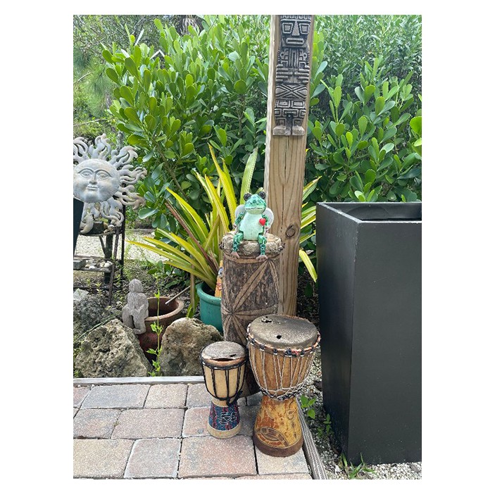 Yard art, bongo drums and a carved totem at Hawks' Point garden in Verandah